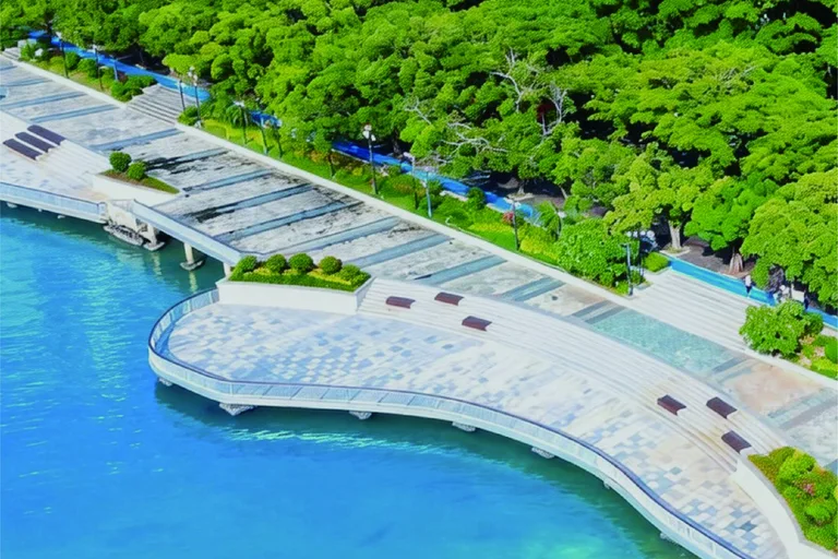 A curving waterfront promenade beside green trees